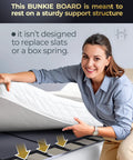 Woman demonstrating Rock Solid Queen Bunkie Board 10mm Slim Low Profile Mattress Support 60x80 on slatted bed frame.