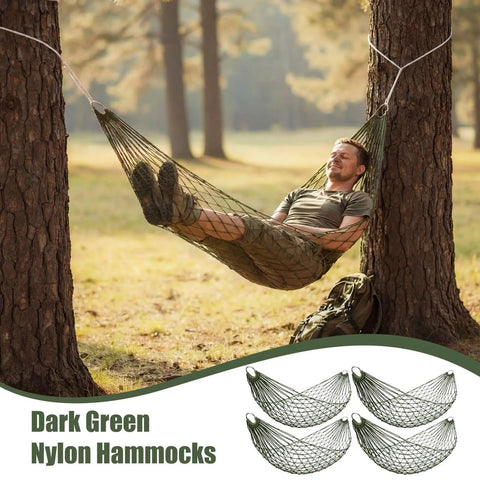 Man relaxing in a pine green mesh hammock tied between trees, part of the 4 Pack Mesh Hammocks Set For Outdoor Chill Pine Green Nylon Hammocks.