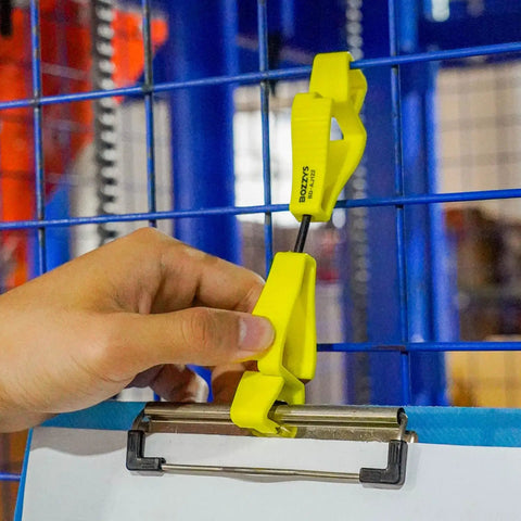 Hand using Yellow Glove Clips For Work Glove Holders 6 Pack Pro-Grade POM Z-Shaped Anti-Drop on blue rail to secure item