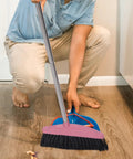 Person using a Long Handle Broom With Dense Stiff Bristles Heavy Duty Floor Sweeper on hardwood floor.