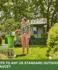 Garden hose, 50 ft gray, used outdoors for watering plants in a backyard garden.