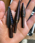 Pro Multi Size Step Drill Kit 5 Piece Hss With Cool Spiral Flute Design For Clean Holes And Less Heat Buildup To Get Your Metal Or Plastic Drilling Projects Done Fast And Super Tough. HSS step drill bits in hand