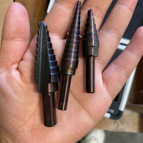 Pro Multi Size Step Drill Kit 5 Piece Hss With Cool Spiral Flute Design For Clean Holes And Less Heat Buildup To Get Your Metal Or Plastic Drilling Projects Done Fast And Super Tough. HSS step drill bits in hand