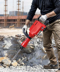 Worker using 2200W Corded Electric Demolition Jack Hammer Drill Heavy Duty Concrete Breaker Kit for masonry work