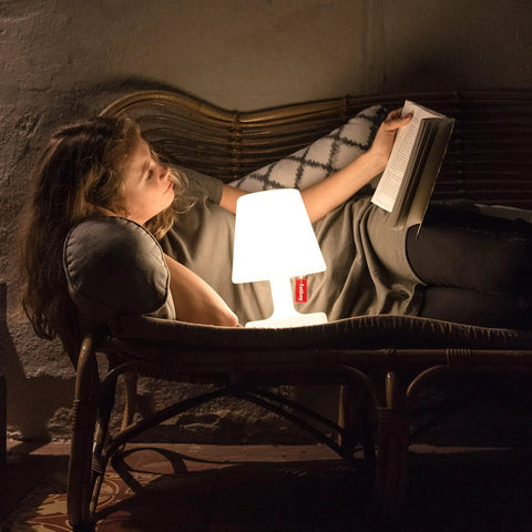 Woman reading by Tiny Rechargeable LED Lamp 2.0 Go Anywhere Dimmable Table Light For Indoor And Outdoor Use Bright 58 Lumens