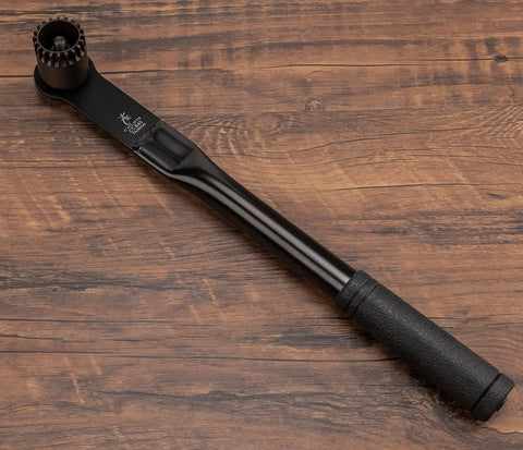 Bottom Bracket Removal Tool For Cartridge Type 20 Tooth Splined Systems Pro Grade with long handle on wooden surface
