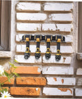 Heavy Duty Wall Mounted Power Tool Holder With Rock Solid Steel Garage Storage Rack For Drills And Hand Tools holding four drills on a wall.