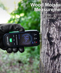 Digital Wood Moisture Meter With Pin Probes measuring tree moisture, showing display and pin probes in use for DIYers and inspectors.