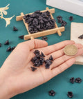 Black Acrylic Flower Bead Caps 100 Pcs Five Petal Frosted Resin Flower Spacers in hand on green surface