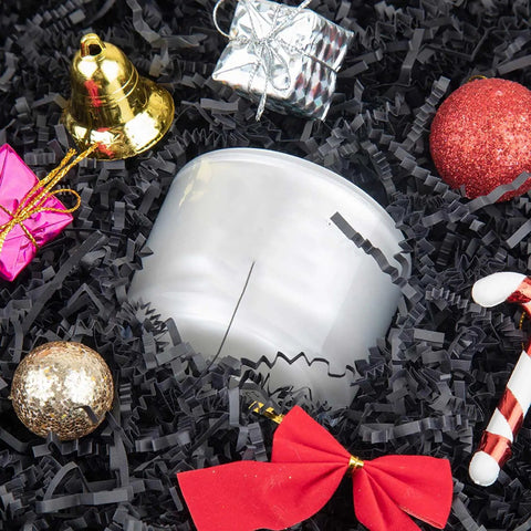 Hassle Free Black Crinkle Cut Paper Shred Filler For Gift Baskets And Boxes with festive decorations and a candle.