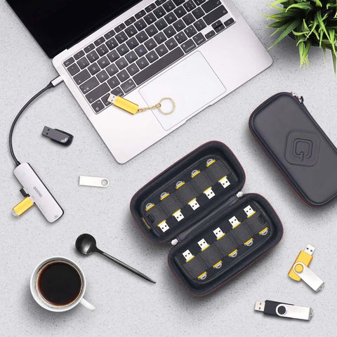 Slick Flash Drive Case and USB Stick Organizer for Keeping Thumb Drives Locked Down Tight During Everyday Commutes with Hella Secure Snap Closure and Comfortable Pocket Friendly Profile, shown with USB sticks and laptop.