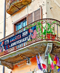 250th Anniversary American Banner Flag 1776 2026 Patriotic Decor on balcony with iron railing, visible flags below.