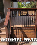 Upgrade Your Deck Game With These Rock Solid 26 Inch Hollow Round Aluminum Balusters In A Slick Matte Black Finish Easy Rack And Stack Setup For Railing Projects tough matte black balusters installed in a wooden railing.
