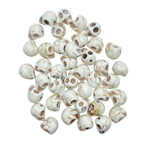 40 Pack 12mm White Skull Beads For Jewelry Making Howlite Skeleton Beads scattered on a surface, ideal for goth craft supplies.