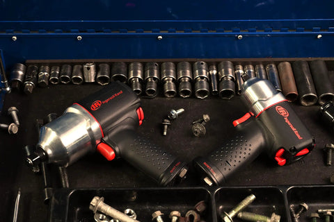 Heavy Duty Half Inch Drive Pneumatic Air Impact Wrench Delivers Over 1100 Ft Lbs Of Bone Crushing Torque in a toolbox with sockets.