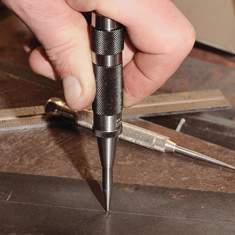Hand holding 18A Steel Automatic Center Punch With Adjustable Stroke, 5 Inch Length, Knurled Steel Handle, 9/16 Inch Punch Diameter