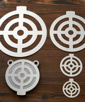 Five Piece AR500 Steel Target Set For Shooting, 3, 4, 6, 8, And 10 Inches Gong Targets on wooden surface