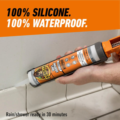 Side view of Gorilla 100% silicone sealant cartridge, 10 oz, clear, held in hand for caulking.