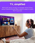 Cozy living room scene with a woman using a remote to control the Next Level HD Media Stick Player With Clutch Voice Remote.