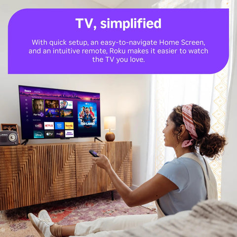 Cozy living room scene with a woman using a remote to control the Next Level HD Media Stick Player With Clutch Voice Remote.