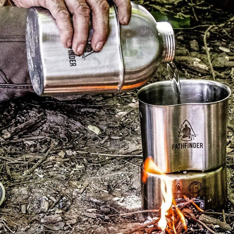 Pouring water from Stainless Steel Canteen Cooking Set For Survival Camping Nestable Mess Kit into cup over open fire