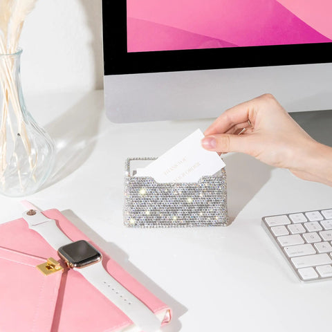 Hand placing card into Blinged Out Business Card Holder Stand For Desk And Office, Crystal Rhinestones, White Glitter Display