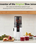 Hurom H70 Cold Press Juicer Easy To Clean Masticating Slow Juicer with black design on kitchen counter surrounded by fruits.