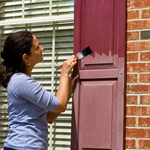 Woman applying Go To Exterior Restorer Kit That Brings Back Original Color And Revives Faded Shutters Patio Furniture Garage Doors