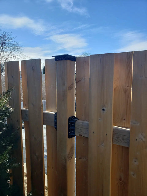 Top Shelf Heavy Duty Privacy Fence Brackets For Standard 2x4 Wood Railings Pre Drilled Galvanized Steel 8 Pack attached to wooden fence.