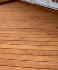 Heavy Duty Wood Stain And Sealer In One For Decks, 5 Gallon semi-transparent coating on smooth wood deck in light walnut.