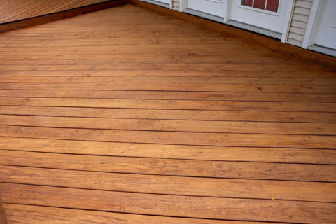 Heavy Duty Wood Stain And Sealer In One For Decks, 5 Gallon semi-transparent coating on smooth wood deck in light walnut.