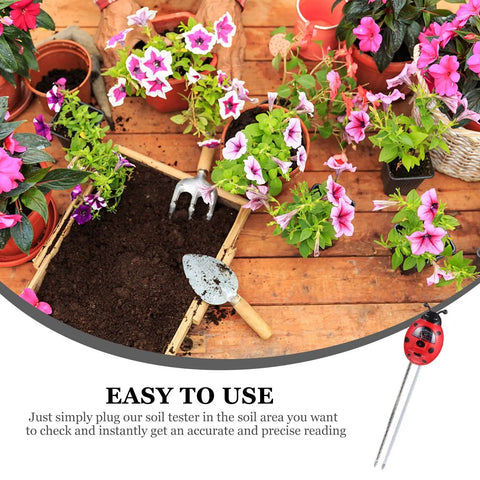 Garden scene with a 3 In 1 Ladybug Soil Tester Kit for Garden and Lawn Soil pH Moisture and Nutrient Checker among flowers and tools