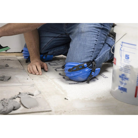 Person using KN-1 Ultralight Knee Pads with maximum comfort and strong grip while working on tiling project, visible blue nonskid outer shell