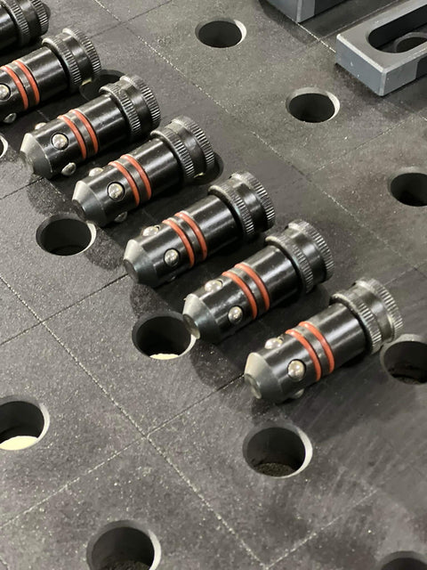 Five Eighths Inch Quick Release Ball Lock Pins For Modular Welding Fixture Tables Two Pack Built Tough And Heavy Duty Solid Steel Positioning Accessories For Fast Easy Setup And Quick Removal shown installed on table