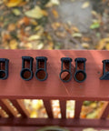 Black Tiki Torch Deck Or Fence Mount for One and One Eighth Inch Outside Diameter Poles shown on deck railing