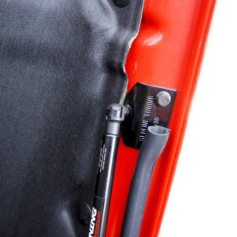 Close-up of Hood Quicklift Kit For Jeep Wrangler JL 2018 And Gladiator 2020 Plus Aluminum Hood Support System attached to red hood