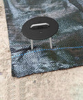 Installed heavy duty metal stake with gasket washer securing landscape fabric, part of 100 Pack 6 Inch Landscape Staples for garden use.