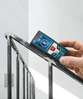 Hand holding GLM 50 C Laser Distance Meter 165 Ft with Backlit Display measuring stair railing