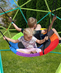 Children on saucer swing attached to Climbing Dome Swing Set With Saucer Swing For Kids Outdoor Backyard Playground 800 Pound Capacity Rust Resistant Easy Assembly Jungle Gym For Ages 3 8 12 Kid Tested Family Fun
