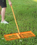 Person using Heavy Duty Lawn Leveling Rake With 72 Inch Adjustable Handle For Soil Sand And Grass, 30 By 10 Inch Head.