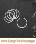 C Shaped Retaining Ring Set Five Piece Stainless Steel Snap Rings shown on a textured black surface with wires.