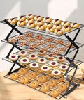 Game-Changing 4-Tier Collapsible Cooling Rack for Baking, Folding Grid With Adjustable, Stackable Design loaded with pastries.