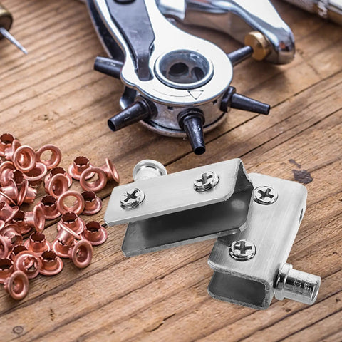 Close-up of Stainless Steel Glass Door Hinges for 5 to 7mm Thick Glass, shown with tools on a wooden table.