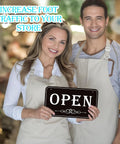 Owners holding Open Closed Sign For Biz 12x6.7 Inches Waterproof Double Sided Hanging Sign in store.