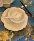 31 Inch To 35 Inch Tempered Glass Lazy Susan Turntable With Quiet Aluminum Base, dishes and chopsticks on glass surface.