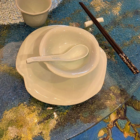 31 Inch To 35 Inch Tempered Glass Lazy Susan Turntable With Quiet Aluminum Base, dishes and chopsticks on glass surface.