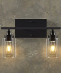 2 Light Black Industrial Bathroom Vanity Light Over Mirror Wall Sconce With Clear Glass Shades mounted on a gray wall