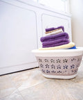 Collapsible Laundry Basket With Handles, Small Taupe White Pop Open Waterproof Plastic Bin beside washing machine, towels inside