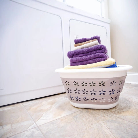Collapsible Laundry Basket With Handles, Small Taupe White Pop Open Waterproof Plastic Bin beside washing machine, towels inside