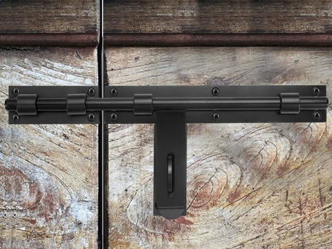 Heavy Duty 17-Inch Carbon Steel Slide Bolt Latch installed on a wooden barn door, designed for security with left or right hand mount.